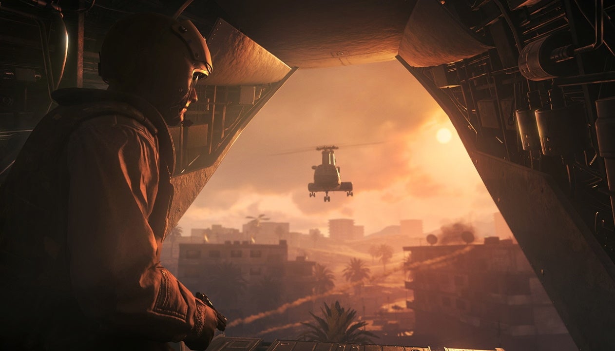 An image from Call Of Duty: Modern Warfare Remastered which shows a soldier riding in the back of a helicopter as the sun sets on the horizon.